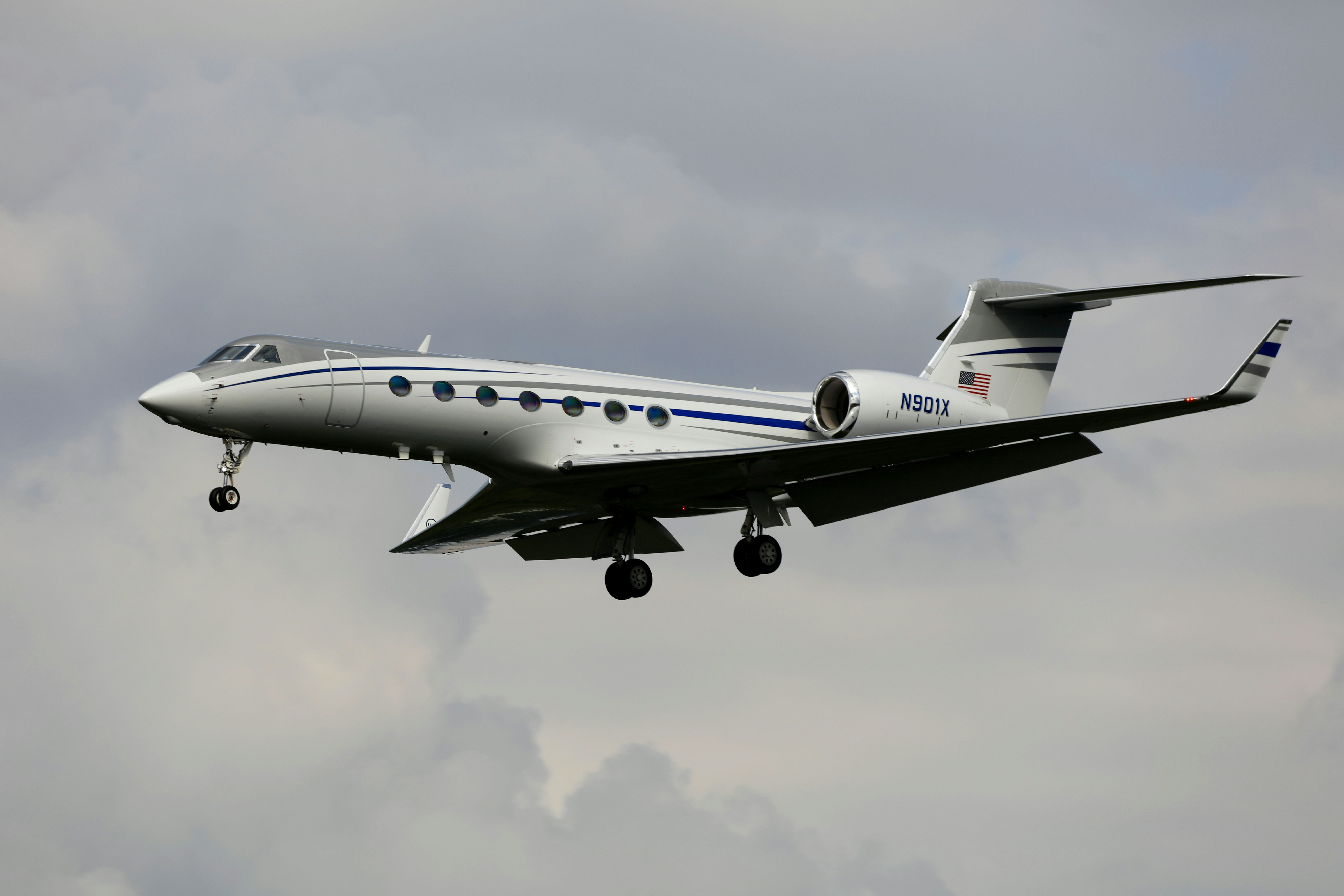 Luxury Gulfstream G550 private jet soaring through a clear blue sky, representing premium travel in the private aviation industry