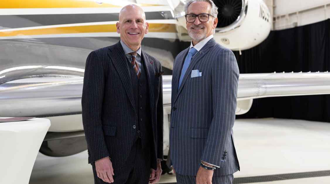 Flexjet CEO Michael Silvestro (l.) and Michael Amalfitano, president and CEO of Embraer Executive Jets celebrate the signing of a massive aircraft order.